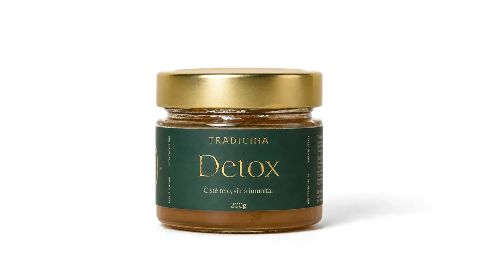 Pohár Detox sa otvára, okolo neho sa vznášajú kurkuma, pestrec, palina, púpava a baza